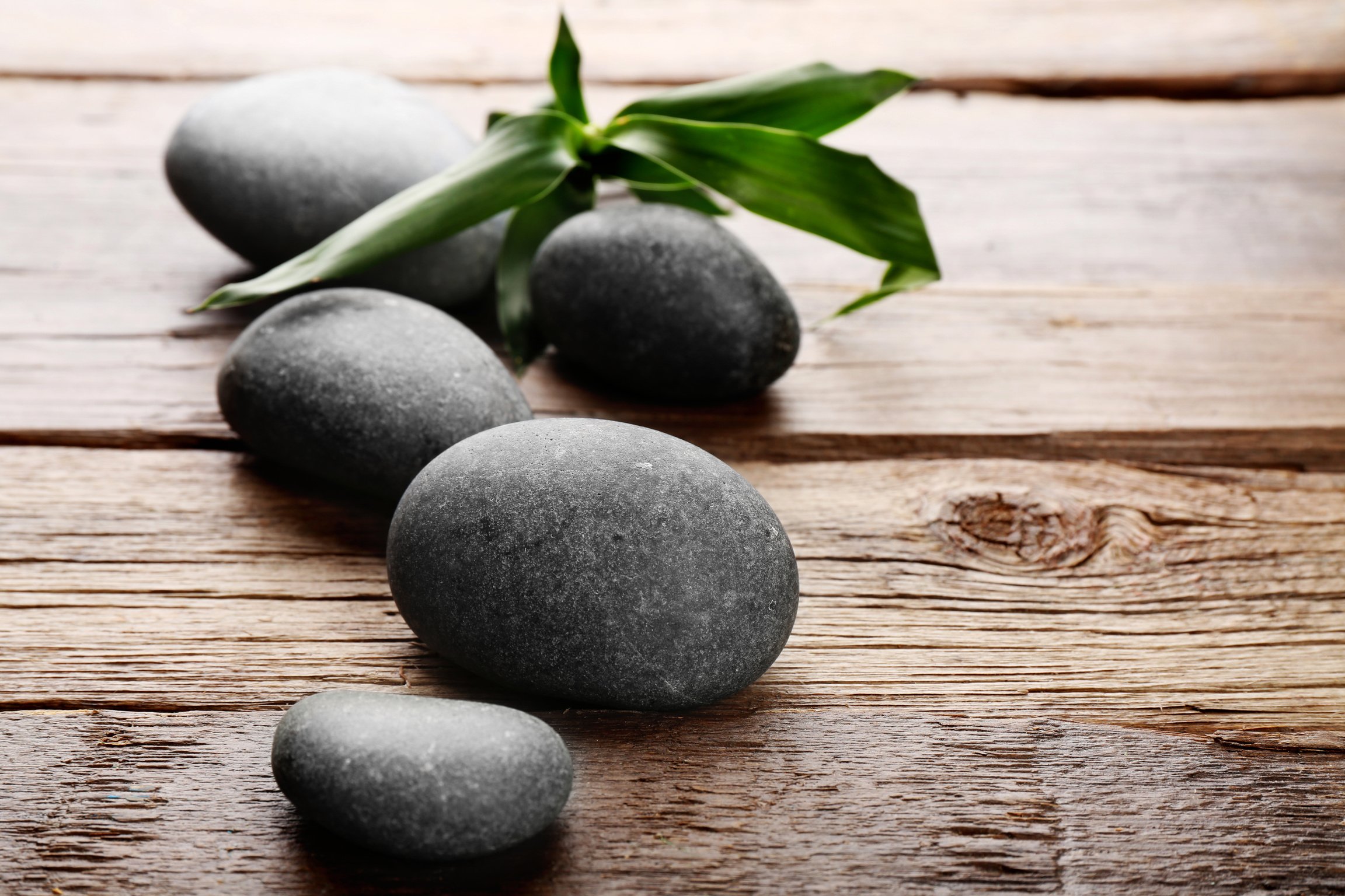 Spa Hot Stones on Wooden Table